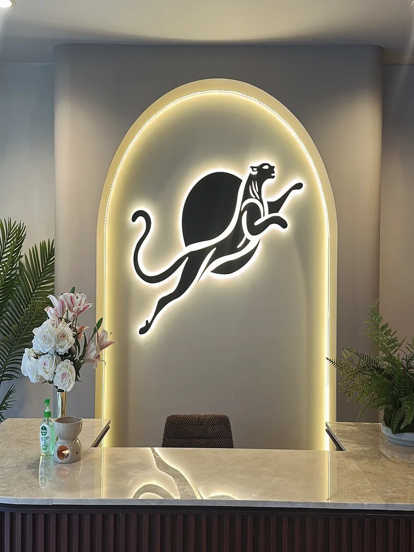 Panthera Pilates reception with illuminated panther logo